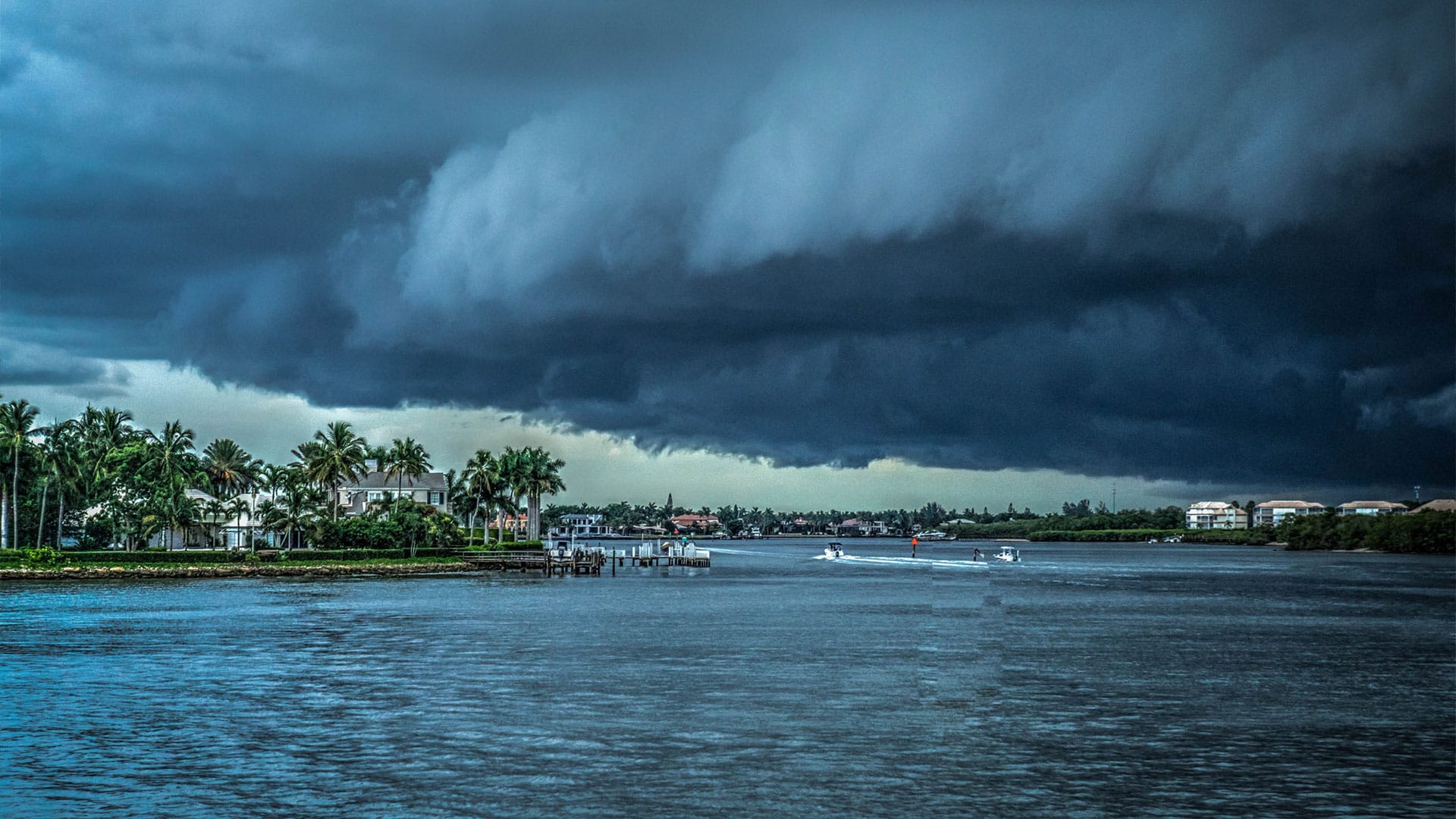 Big dark storm clouds coming in over sea and land in Florida