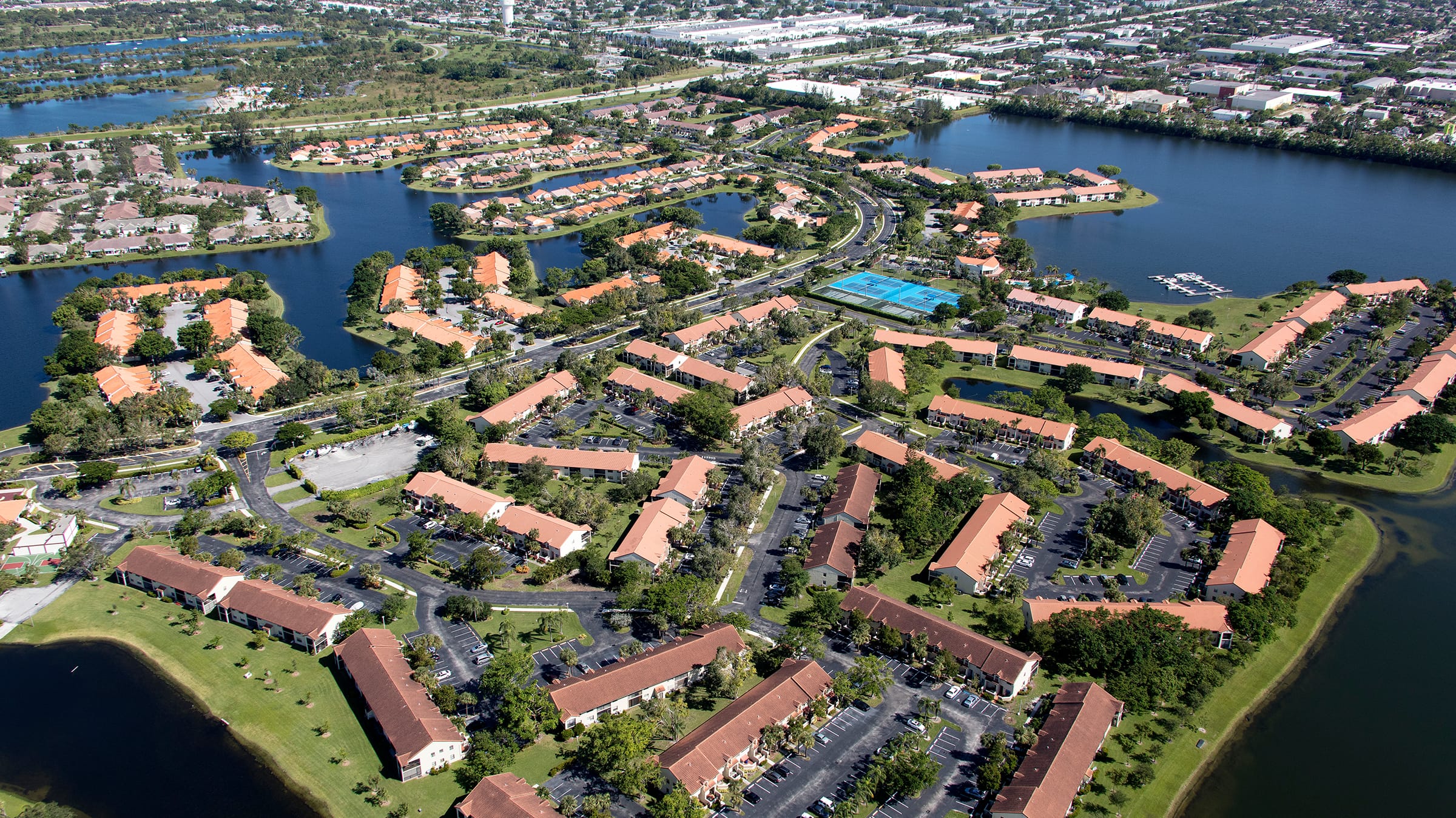 Birdseye view of a housing community with greenery and canals