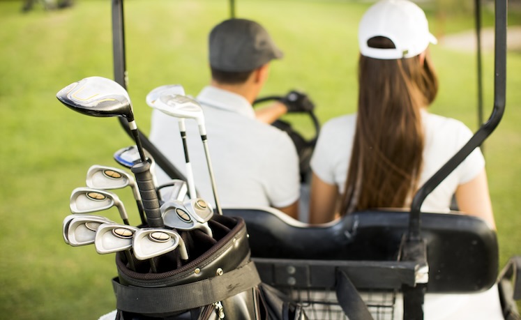 couple on golf cart