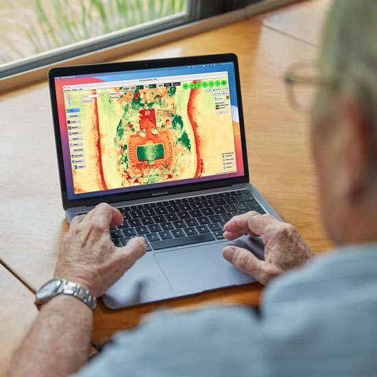 An older man looking at the Flowguard heat maps on a laptop computer
